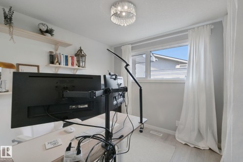 Recessed window with white trim, wood-finish flooring, built-in shelving, and a decorative ceiling light fixture - 5 Labelle Crescent, St. Albert, AB 