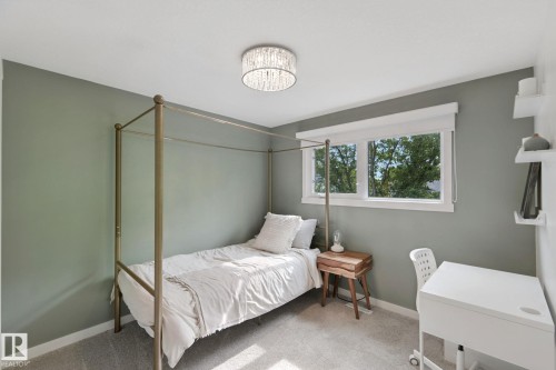 Recessed window, contemporary drum chandelier, light-toned carpeting, neutral wall color, and white trim - 5 Labelle Crescent, St. Albert, AB 