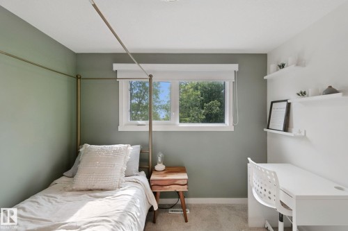 Neutral wall paint, window with white trim, built-in wall shelves, and carpeted flooring - 5 Labelle Crescent, St. Albert, AB 