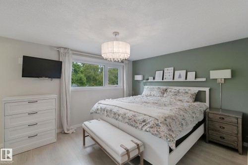Wood-finish flooring, accent wall, and window with exterior scenery - 5 Labelle Crescent, St. Albert, AB 