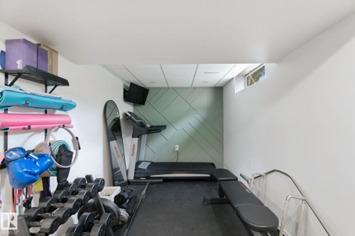 Finished interior space featuring a drop ceiling, window, and a decorative accent wall - 5 Labelle Crescent, St. Albert, AB 