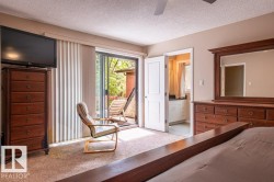 Carpeted interior space with direct access to an exterior balcony - 
