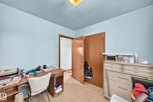 Light blue walls with a contrasting ceiling, wood-finish flooring, and natural wood doors - 15703 84 Avenue Nw, Edmonton, AB - Indoor Photo Showing Office