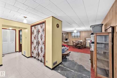 Basement room featuring a dropped ceiling, wood-paneled walls, and a recessed window - 15703 84 Avenue Nw, Edmonton, AB - Indoor Photo Showing Other Room