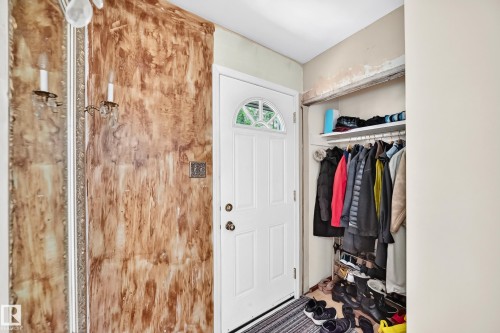 White paneled entry door with an arched window insert - 15703 84 Avenue Nw, Edmonton, AB - Indoor Photo Showing Other Room