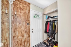 White paneled entry door with an arched window insert - 