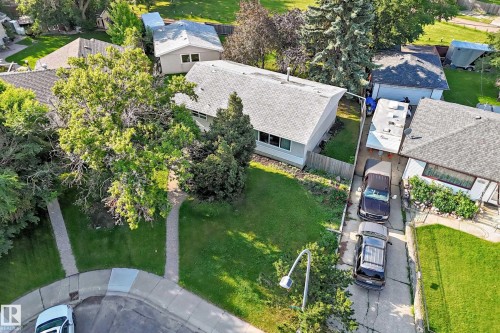 Spacious residential property featuring mature trees and a manicured lawn - 15703 84 Avenue Nw, Edmonton, AB - Outdoor