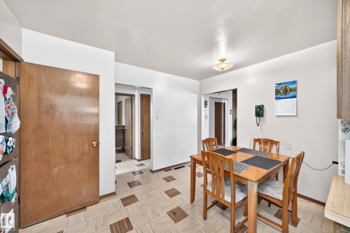 Dining area featuring a patterned flooring, white walls, and a ceiling-mounted light fixture - 15703 84 Avenue Nw, Edmonton, AB - Indoor Photo Showing Dining Room