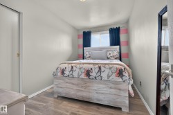 Sliding closet door with gold-tone hardware, wood-finish flooring, and a large window - 