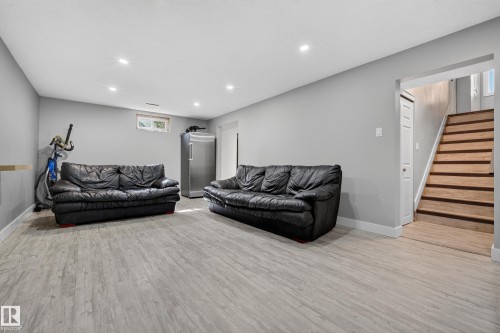 Recessed ceiling lighting, wood-finish flooring, light gray wall finishes, and a window - 13512 111 Street Nw, Edmonton, AB 