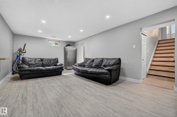 Recessed ceiling lighting, wood-finish flooring, light gray wall finishes, and a window - 