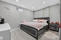 Recessed ceiling lighting, light wood-finish flooring, a fixed window with security bars, and a built-in wall niche - 