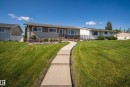 Expansive front lawn with a concrete pathway leading to the entrance - 13512 111 Street Nw, Edmonton, AB 