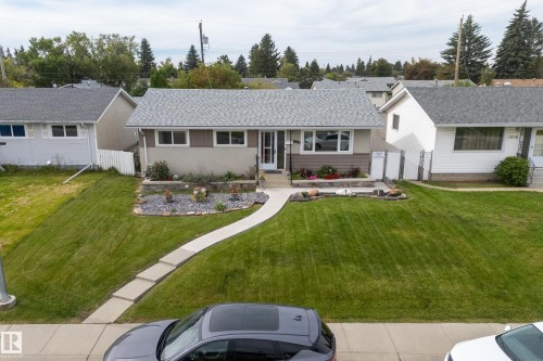 Single-story residence featuring a gray shingle roof and a concrete walkway - 13512 111 Street Nw, Edmonton, AB 