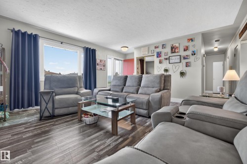 Wood-finish flooring throughout, recessed lighting, and a window with a distant landscape - 13512 111 Street Nw, Edmonton, AB 