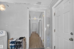 Hallway with wood-finish flooring and flush-mount lighting - 