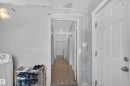 Hallway with wood-finish flooring and flush-mount lighting - 9124 119 Avenue Nw, Edmonton, AB  - Indoor 