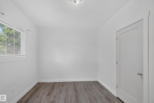 Interior room with wood-finish flooring and white baseboards - 9124 119 Avenue Nw, Edmonton, AB - Indoor Photo Showing Other Room