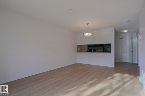 Open concept living space featuring wood-finish flooring - #108 1204 156 St Nw, Edmonton, AB 