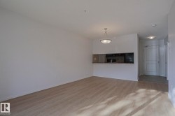 Open concept living space featuring wood-finish flooring - 