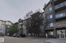 Multi-story apartment building with stone veneer accents - 