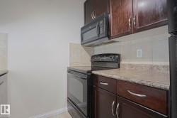 Dark wood-finish cabinetry, light-toned countertops, and a tile backsplash - 