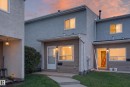 Multi-story townhouse exterior featuring a stucco and siding facade, white window frames, and a concrete walkway - 17749 95 Street Nw, Edmonton, AB 