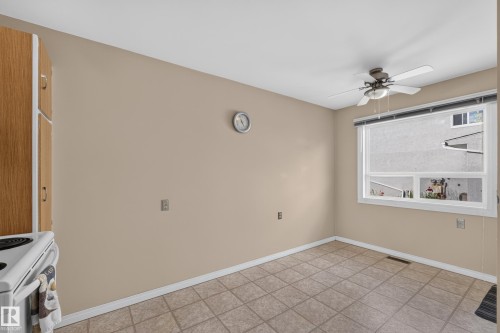 Recessed lighting with a ceiling fan, window with horizontal blinds, and wood-finish cabinetry - 17749 95 Street Nw, Edmonton, AB 