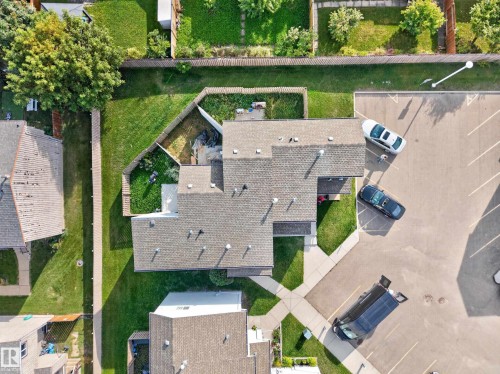 Multi-unit building featuring a shingled roof and surrounding green space - 17749 95 Street Nw, Edmonton, AB 