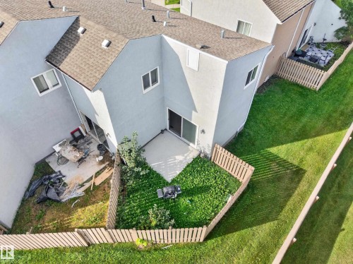 Private fenced yard featuring a concrete patio and green space - 17749 95 Street Nw, Edmonton, AB 