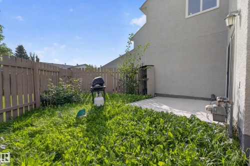 Backyard patio with concrete surface, privacy fencing, and exterior wall with a window - 17749 95 Street Nw, Edmonton, AB 