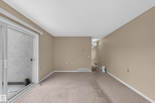 Neutral wall color, carpet flooring, sliding glass door, white trim, recessed lighting - 17749 95 Street Nw, Edmonton, AB 