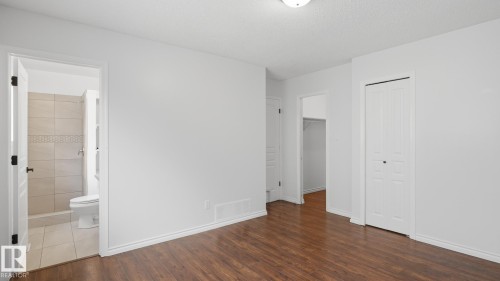 Wood-finish flooring, white walls, and white trim - 12208 146 Avenue Nw, Edmonton, AB 