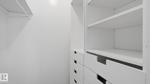 Built-in closet organization system featuring adjustable shelving and integrated drawers - 12208 146 Avenue Nw, Edmonton, AB 