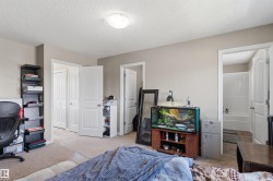 Neutral tone wall paint, textured ceiling, and flush mount lighting - 