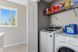 Dedicated laundry area featuring a top-load washer and a front-load dryer - 