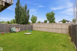 Expansive green lawn surrounded by wood privacy fencing - 