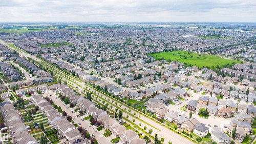 Expansive residential development featuring numerous single-family homes, tree-lined streets, and open green spaces - 1608 65 Street Sw, Edmonton, AB - Outdoor With View