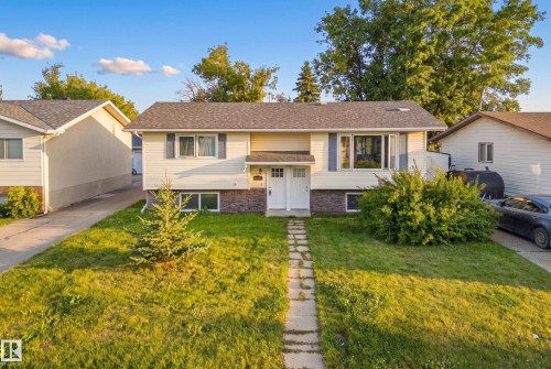 Split-level home featuring vinyl siding and stone accenting - 2412 80 Street Nw, Edmonton, AB 