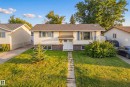 Split-level home featuring vinyl siding and stone accenting - 2412 80 Street Nw, Edmonton, AB 