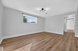 Recessed window with white trim, wood-finish flooring, light gray wall paint, and a contemporary ceiling light fixture - 