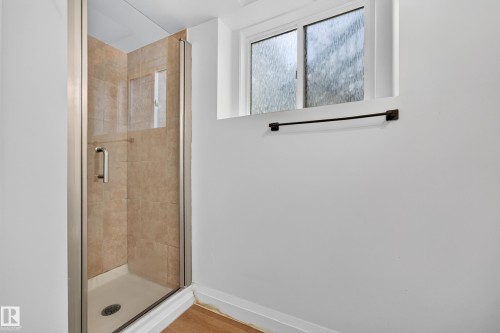 Glass-enclosed shower with tiled walls and a built-in niche - 2412 80 Street Nw, Edmonton, AB 