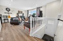 Wood-finish flooring throughout the main living area - 2412 80 Street Nw, Edmonton, AB 