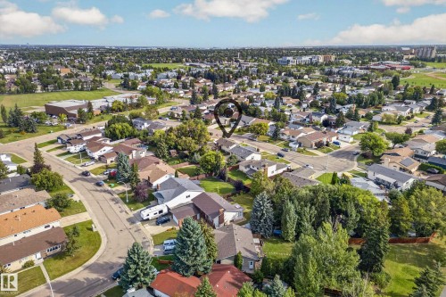 Residential neighborhood featuring mature trees, paved streets, and a mix of single-family homes - 2412 80 Street Nw, Edmonton, AB 