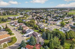 Residential neighborhood featuring mature trees, paved streets, and a mix of single-family homes - 