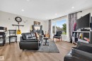 Recessed ceiling lighting, wood-finish flooring, and a large window with white trim - 2412 80 Street Nw, Edmonton, AB 