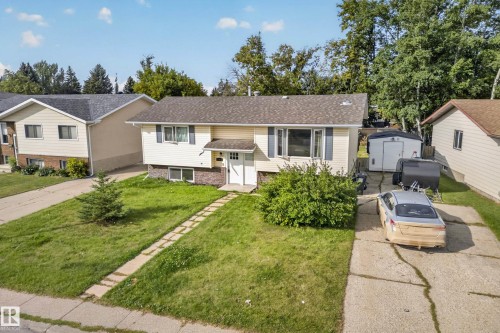 Exterior featuring a pitched roof, light-colored siding, and dark shutters - 2412 80 Street Nw, Edmonton, AB 