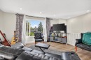 Hard-surface flooring, large window, recessed lighting, and white railing - 2412 80 Street Nw, Edmonton, AB 