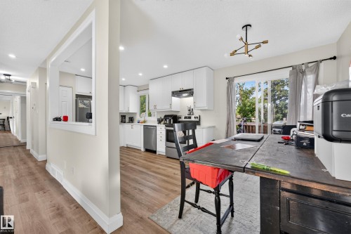 Modern kitchen featuring white cabinetry, stainless steel appliances, and recessed lighting - 2412 80 Street Nw, Edmonton, AB 