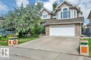 Siding exterior with stone accents, attached garage, concrete driveway, and mature landscaping - 739 Haliburton Crescent Nw, Edmonton, AB 